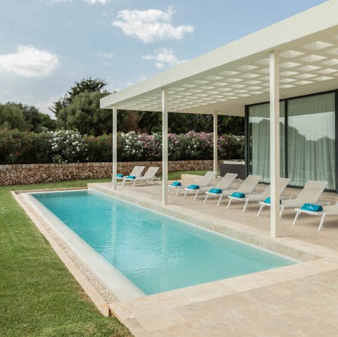 Plunge into the pool tucked between floral trellises
