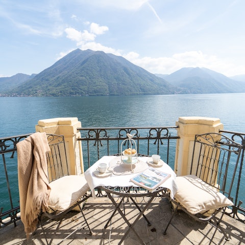 Tuck into a delicious breakfast on the balcony overlooking Lake Como