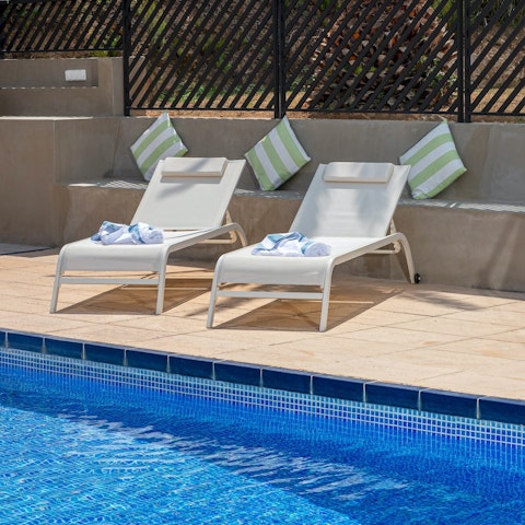 Spend carefree days stretched out by the pool