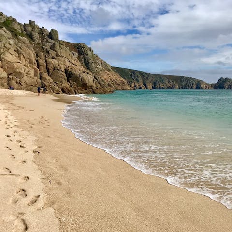Sink your toes in the sand at beautiful Porthcurno Beach, a twenty-five-minute drive from your door