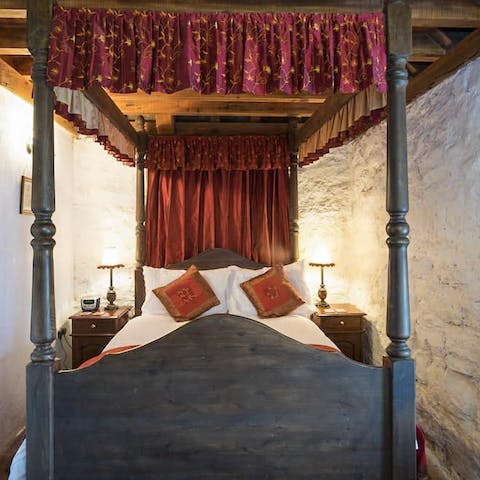 Get some rest in the four poster bed with its silk drapes