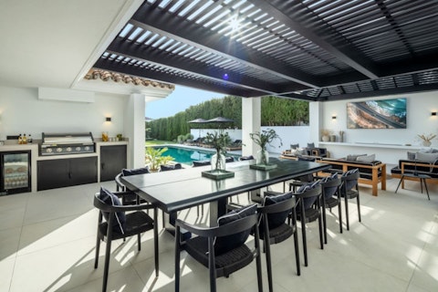Gather under the pergola for long alfresco dinners
