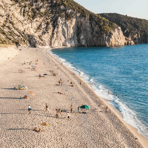 Chill out on the soft sands of Pefkoulia Beach, a six-minute drive from your home