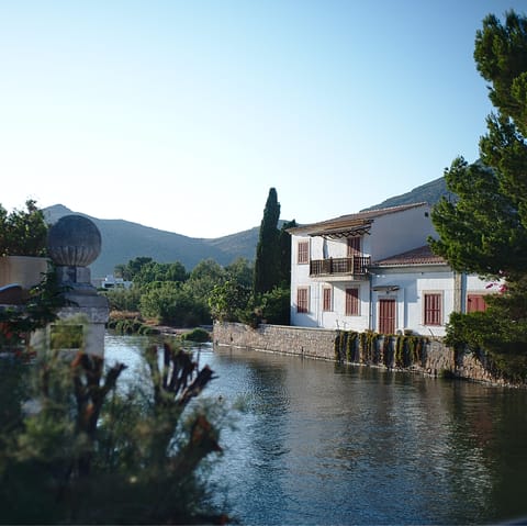 Drive up to Port de Pollença and explore its quaint winding streets