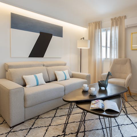 Unwind in the stylish living room with a glass of Spanish wine after a day spent exploring the city