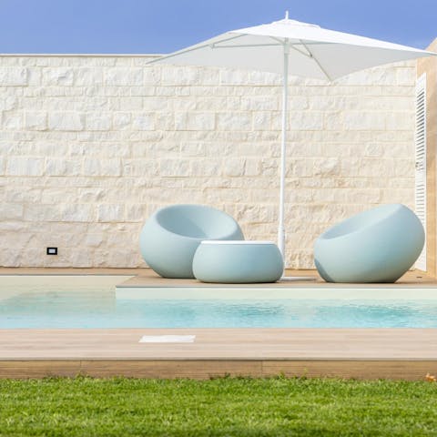 Rest up on the sun chairs after a dip in the pool