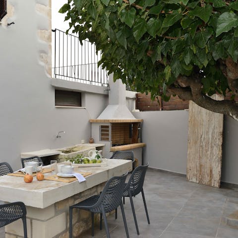 Grill up a storm on the barbecue and dine alfresco under the tree