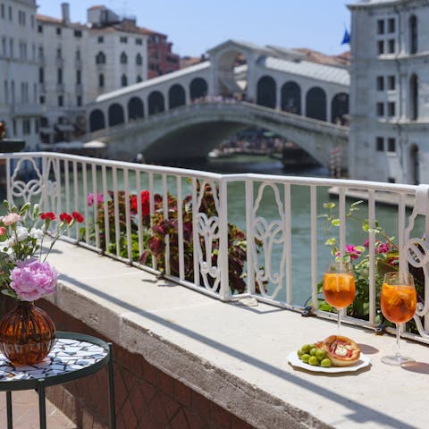 Sip spritz with a front-row view of the Rialto Bridge