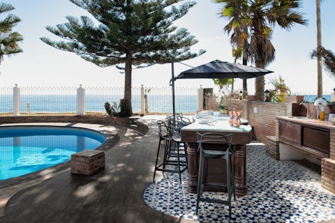 Sip cocktails at the outdoor bar steps from the sea