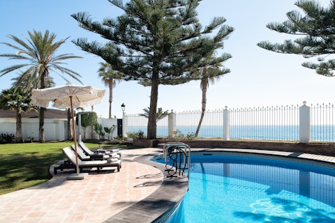 Stretch out beside the pool as the Mediterranean shimmers beyond