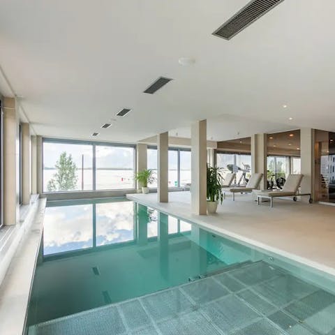 Luxuriate in the communal pool overlooking Lake Geneva