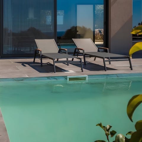 Relax on a lounger by the pool, with your favourite book