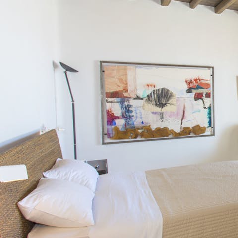 Bright artworks add colour to neutral decor