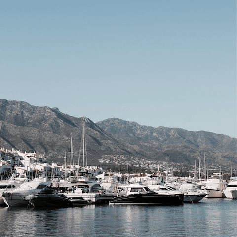 Stroll along the marina boardwalk after dinner in the nearby town of Marbella
