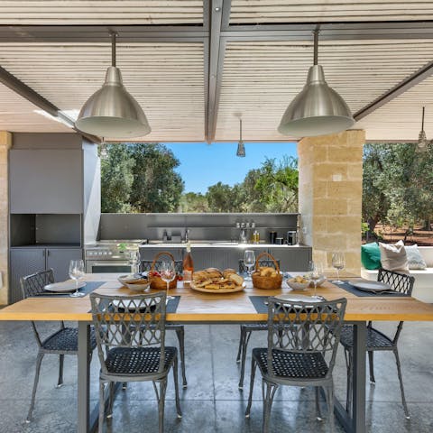 Finish off the pizzas in the sleek outdoor kitchen