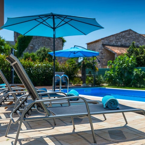 Sunbathe poolside, cocktail in hand