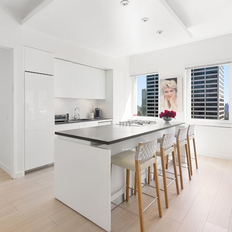 Cook up memorable meals in the kitchen overlooking the city skyline