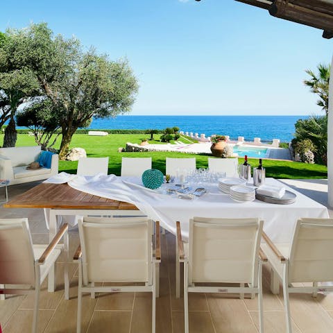 Enjoy alfresco meals in the garden overlooking the glistening sea
