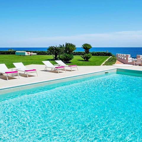 Soak up the sun by the private pool with a stunning sea view