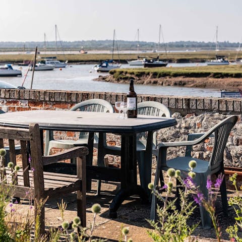 Sip a sundowner on the raised outdoor seating area while watching the boats go by