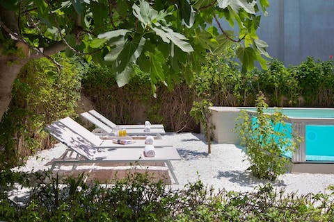 Stretch out on a sun lounger with a good book and a cool drink