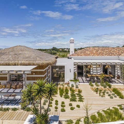 Marvel at the unique features of this traditional thatched roof villa