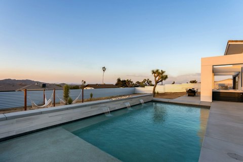 Swim as the desert sky turns pink at sunset