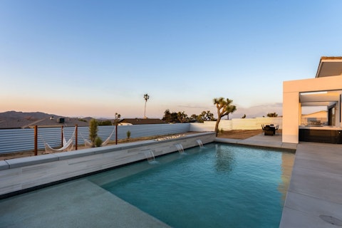 Swim as the desert sky turns pink at sunset