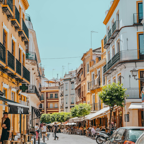Discover Seville's colourful streets fringed with cafes and eateries
