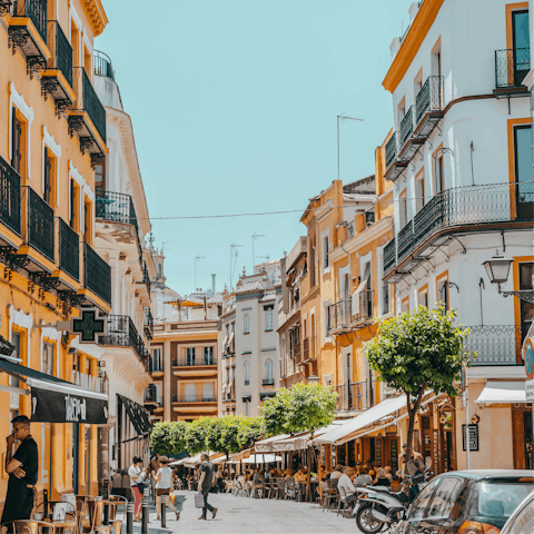 Discover Seville's colourful streets fringed with cafes and eateries