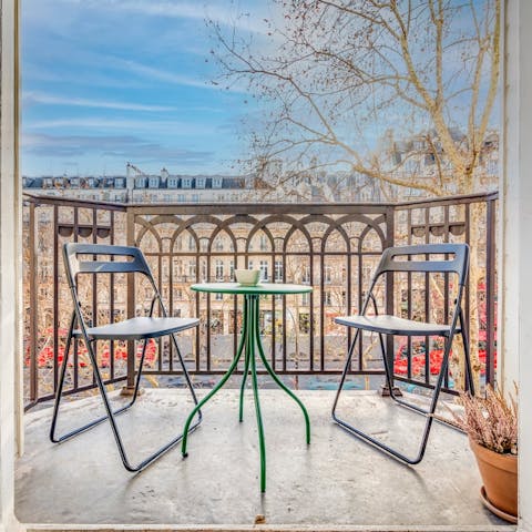 Take in the views of the Parisian architecture from the private balcony