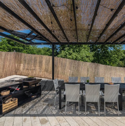 Host alfresco group dinners under the pergola
