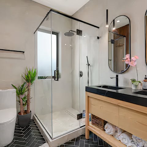 Relax stiff muscles under the rainfall shower in the spa-style bathroom
