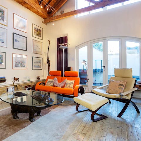 Relax in the living room while admiring the eclectic art