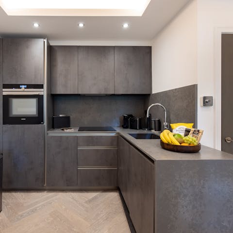 Enjoy preparing meals in the sleek black kitchen