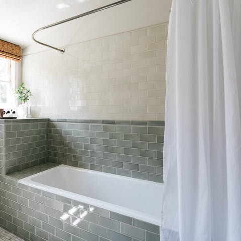 Soak in the teal-tiled bathtub