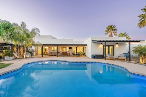 Cool off in the pool as the desert sky turns pink