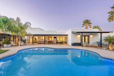 Cool off in the pool as the desert sky turns pink