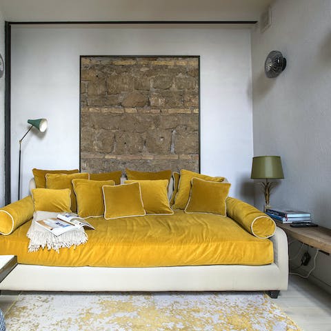 Spread out in the style of a Roman emperor on the huge sofa
