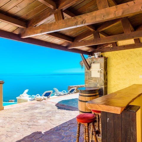 Rustle up sundowners from the outdoor bar area