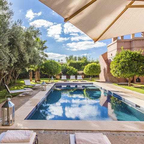 Doze in the shade after a refreshing swim in the private pool