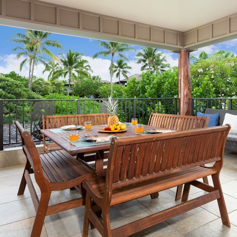 Dine alfresco in the lanai overlooking swaying palms