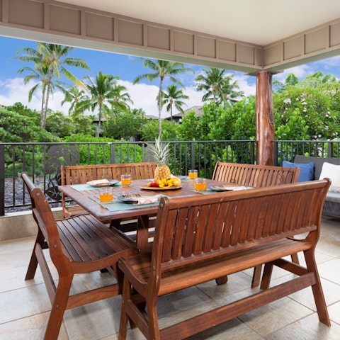 Dine alfresco in the lanai overlooking swaying palms