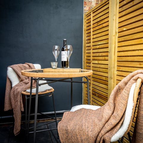 Sip a glass of wine outside in the courtyard after a busy day