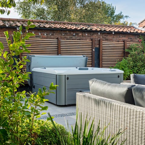 Relax in the hot tub with a glass of cider