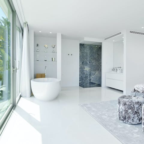 Sink back into soothingly warm water in the elegant freestanding bathtub