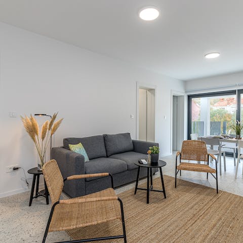 Kick back in the bright living room with a glass of wine after a day at the beach