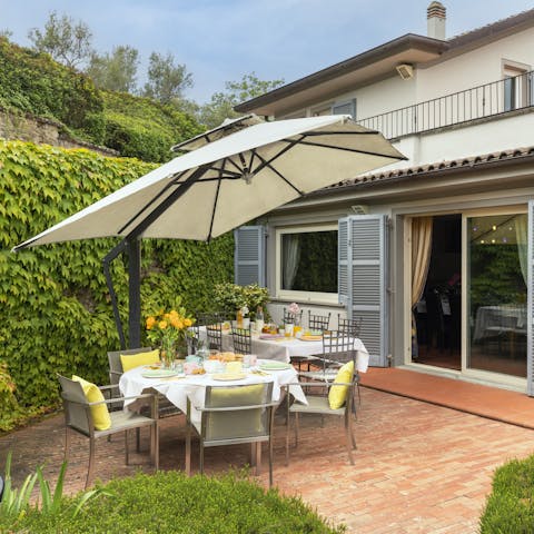 Dine alfresco on one of the multiple terraces, surrounded by the lush garden and mountain views