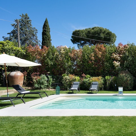 Spend your days around the private pool, enclosed by trees and hedges