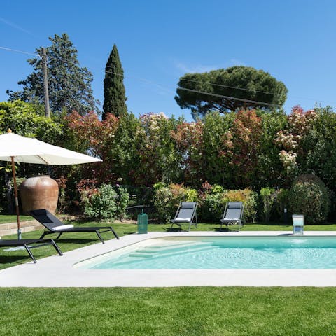 Spend your days around the private pool, enclosed by trees and hedges